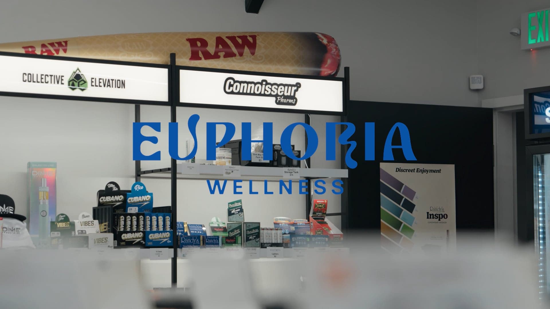 Euphoria Wellness dispensary counter with the blue brand sign on the back wall and product cases in front