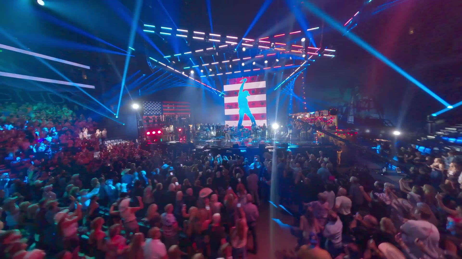 A crowd beneath the illuminated stage at a Toby Keith memorial event